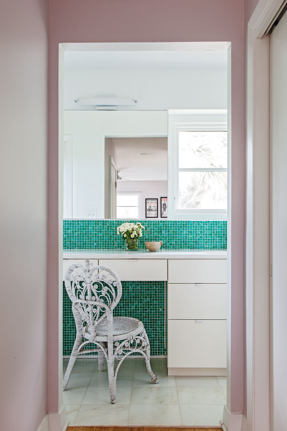MASTER SPLASH: Green glass tiles contrast beautifully against the contemporary white vanity.