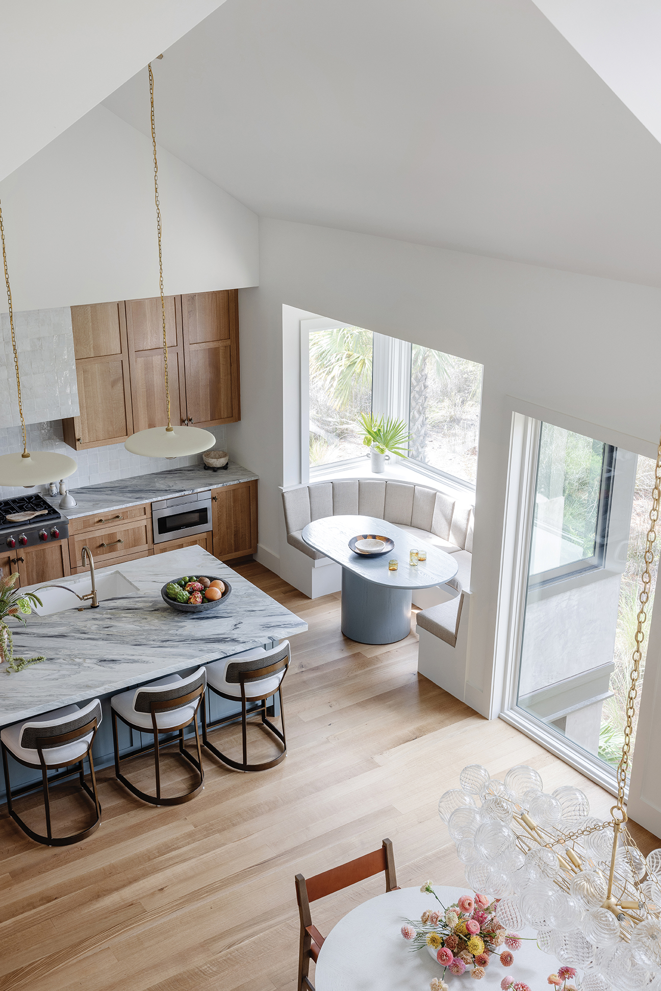 Looking down from the balcony to the kitchen/dining area is light and bright, seamlessly melding the colors of the marsh with the interior space.