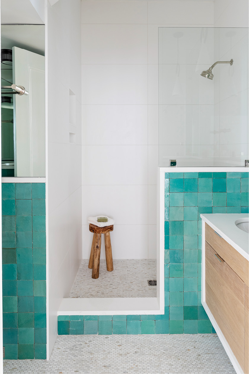 A few steps from there, the guest bathroom adds a splash of color with handmade Moroccan tile from Mosaic House.