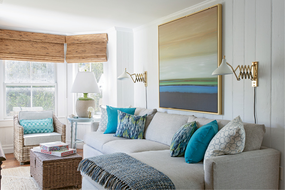 In the family room, colorful pillows from Indigo Market complement the abstract landscape from Wendover Art Group.