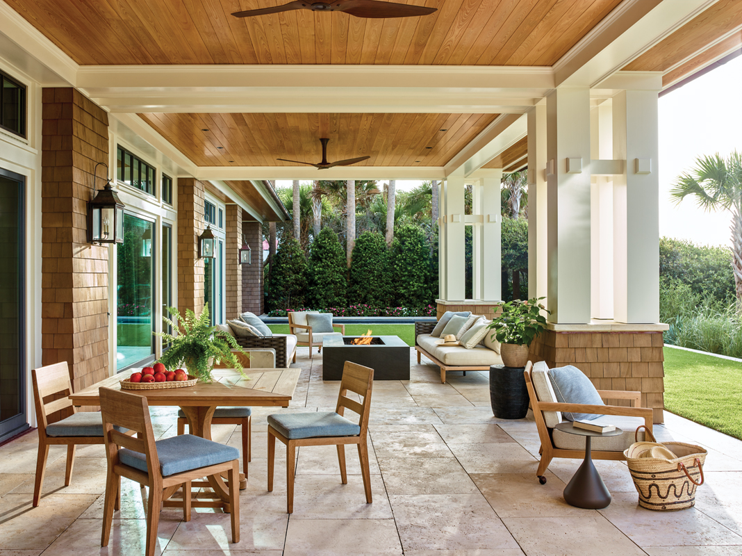 The outdoor dining and living areas are adjacent to their indoor counterparts, reinforcing the indoor-outdoor flow. Dedon settees with teak bases surround a custom fire pit, and an Amish teak table and chairs provide a place for alfresco dining.