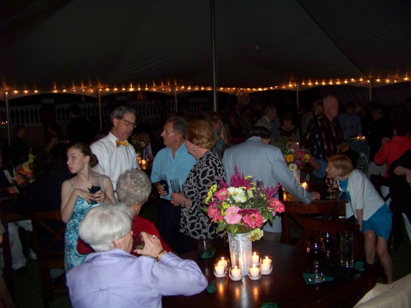 Host Preston Wilson (bow tie) greets guests.