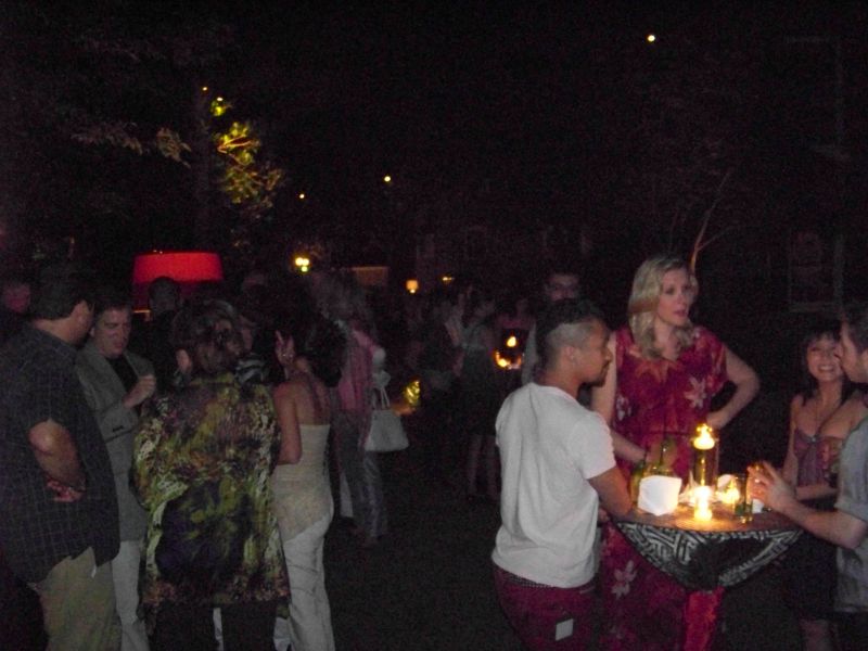 Guests mingled around candlelit tables