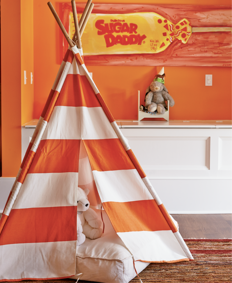 Orange Crush - A new stairwell allowed a young family easy access to this attic space. Vibrant orange paint, built-in toy storage, and a striped teepee made it a spunky playroom.  Location: South of Broad (Villa Margherita, circa 1895,  owned by Mary and Stephen Hammond)  Issue: September 2015, “Viva La Villa”  Photographer: Brie Williams