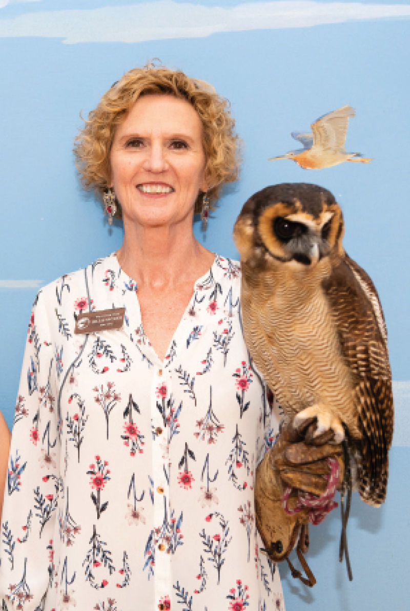 Volunteer staff member Billie Snyder and an Asian brown wood owl