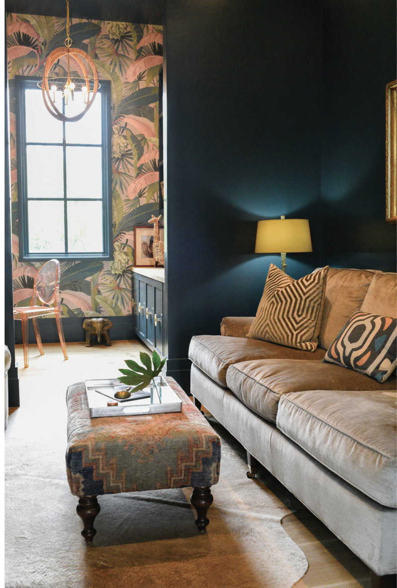 Study Up - In this sumptuous sitting room and office, bold, banana leaf-themed wallpaper by Mokum complements the rich teal walls painted in Sherwin Williams’s “High Battery.” A velvet sofa from Acquisitions Interiors and a custom vintage Turkish oushak ottoman are plush accents.  Location: Mount Pleasant, on Shem Creek (owned by Alix and Mark Bragg) Issue: March 2020, “In the Company of Trees”  Photographer: Mary Kathryn McConaghy