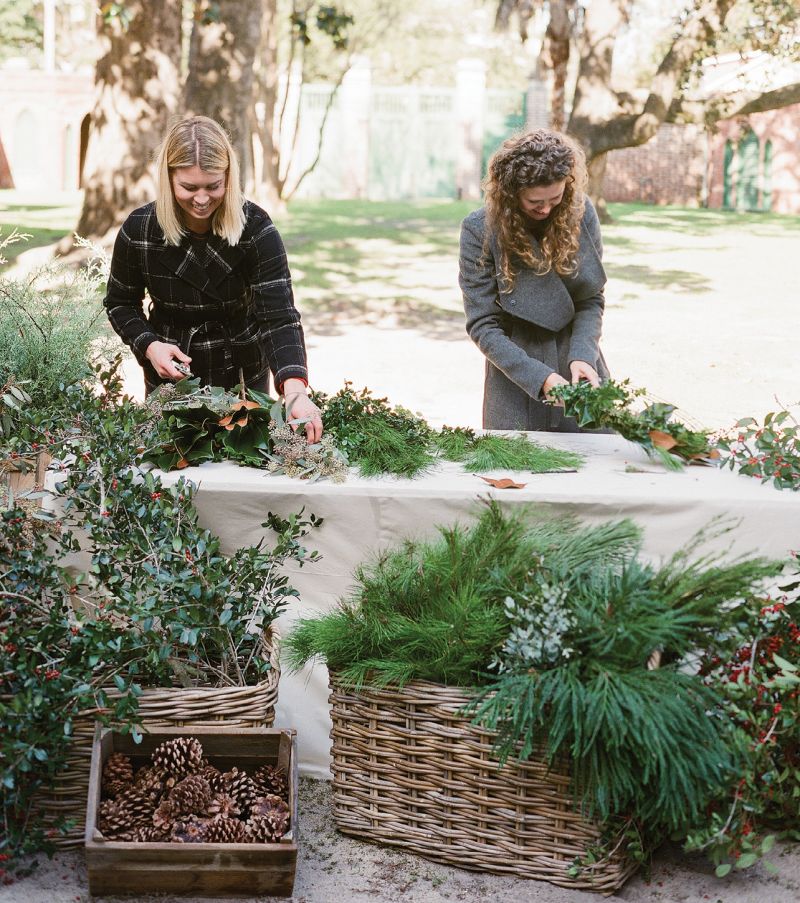 Anne Bowen Dabney (left) and Heather Barrie guide attendees through designing wreaths.