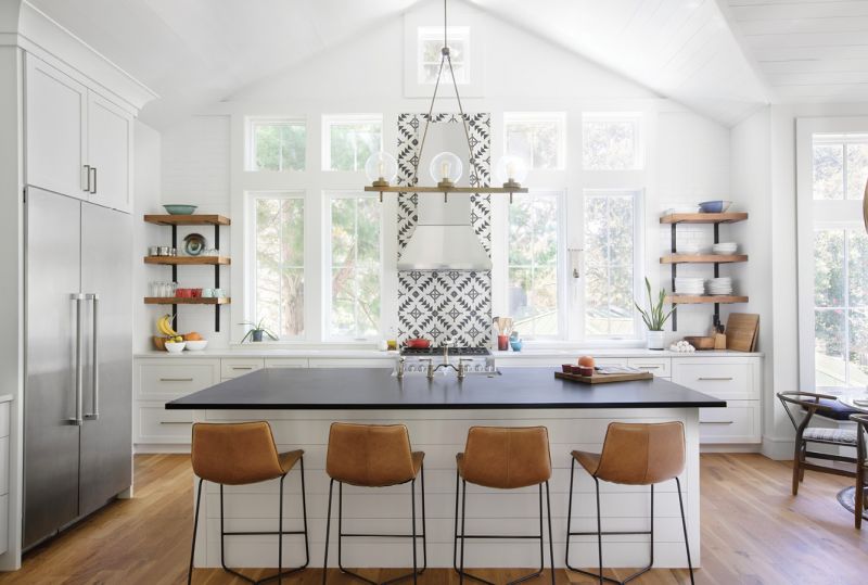 Made to Measure: The kitchen, the house’s raison d’être, is Erin’s happy place. It’s no wonder, as the cabinets, countertops, and shelves were designed and built to suit the avid home cook’s six-foot frame. Other custom features include the walnut shelves by cabinetmaker David Beason and the chandelier from Circa Lighting that perfectly frames the bold geometric backsplash. The black-and-white design was sourced from clé, an artisan tilemaker in California.