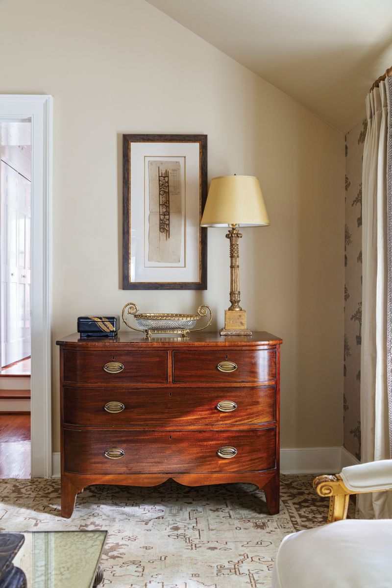 Midas Touch: The Griffins’ antique chest pairs with a French neoclassical Baccarat bowl from Chairish and an Italian gilt-wood lamp from The Antique and Artisan Gallery, topped with a custom lampshade.