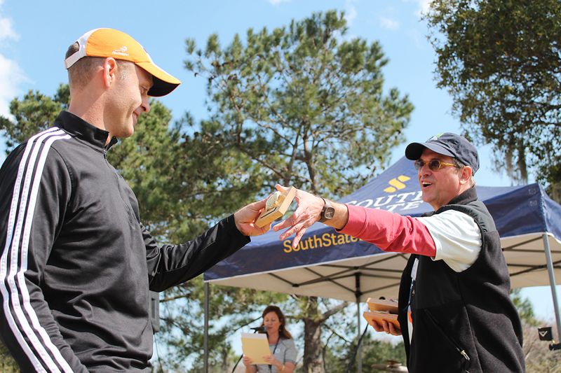 Landon Messal receives his race award from Bill Eubanks