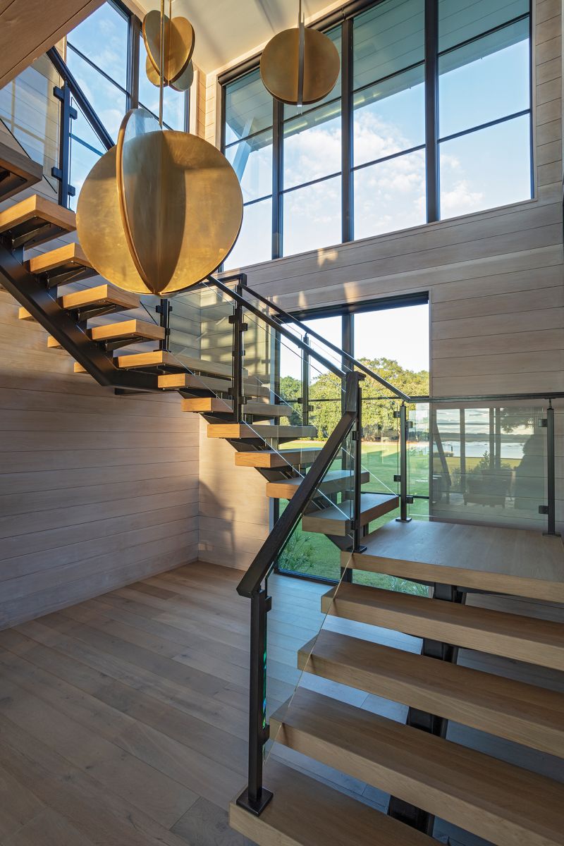 Bold bronze pendant lamps provide a focal point on the stairwell.