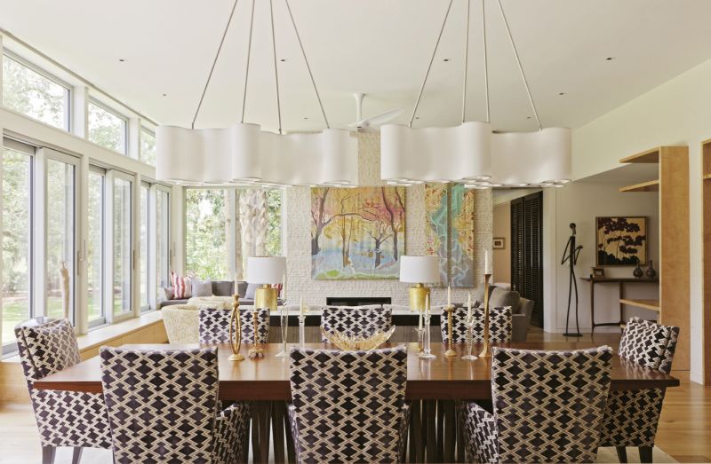 The three-panel batik by local artist Mary Edna Fraser displayed against the split-face-stone tile fireplace in the living room.