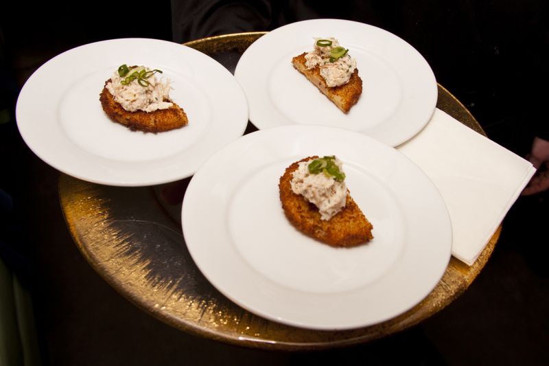 Cocktail waiters offered fried green tomatoes adorned with blue crab.