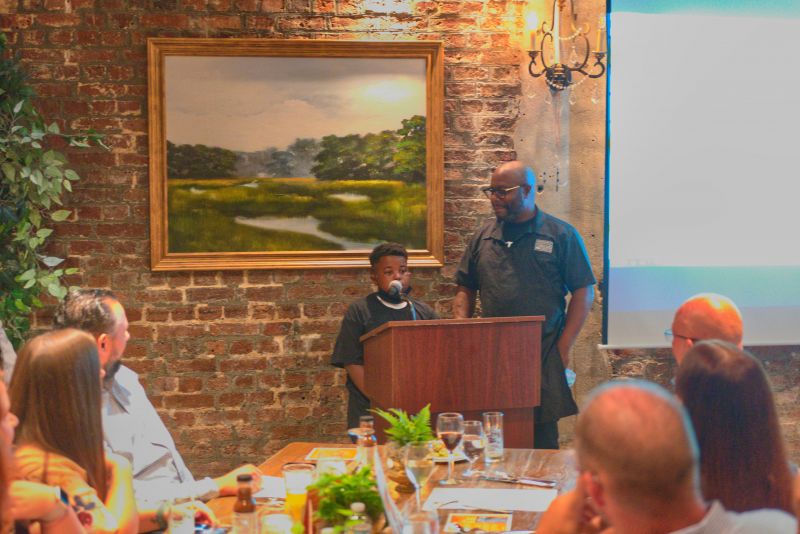 Grant Higgins addresses the crowd with his big chef partner Rodney Scott