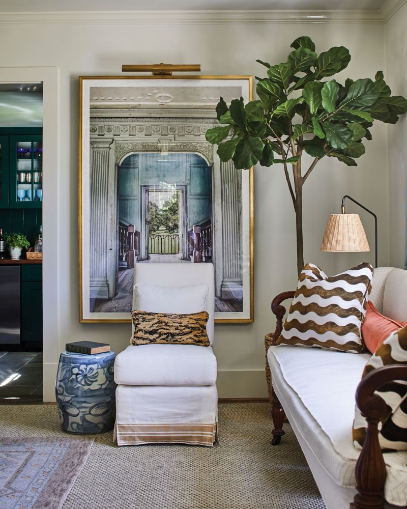 Cooper arranged a Mark Sikes slipper chair and 19th-century settee (the latter of which serves as the seat of choice for the couple’s cockapoo, Harper) to create a secondary sitting nook. Photographer Anne Jervey Rhett’s portrait of Drayton Hall adds depth and intrigue to the space. “I think it turned out great,” says Kruse, who accompanied Anne—a friend of theirs—on the commissioned shoot.