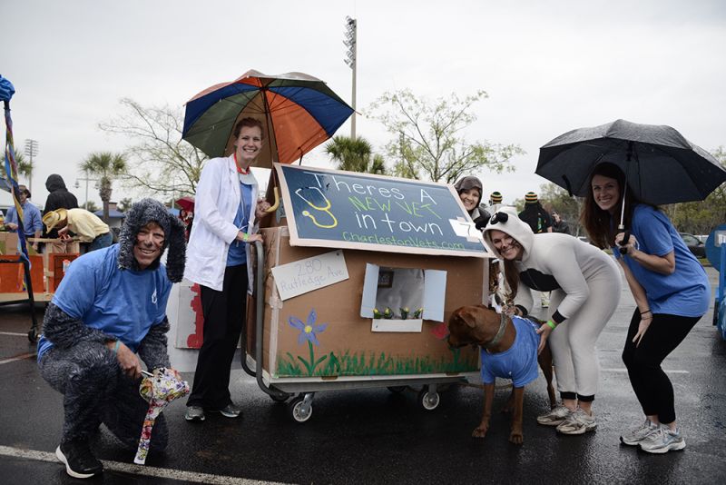 Charleston Harbor Vets took cover in the rainy weather while Leo the pup sniffed the flowers.