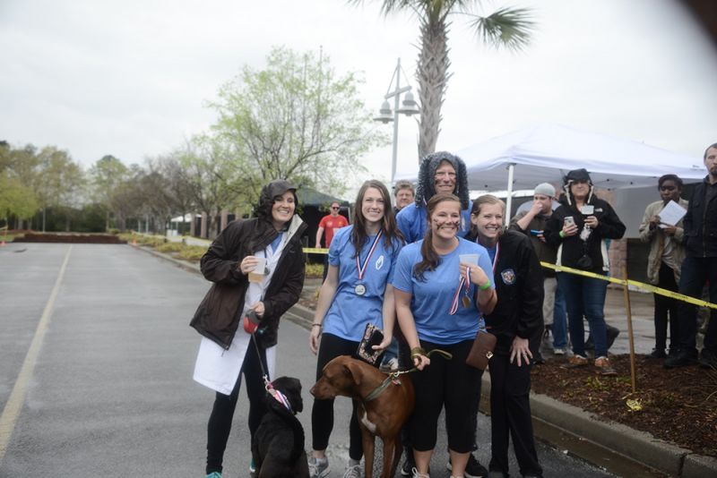 Charleston Harbor Vets posed with playful pups Leo and Gizi after receiving their medals.