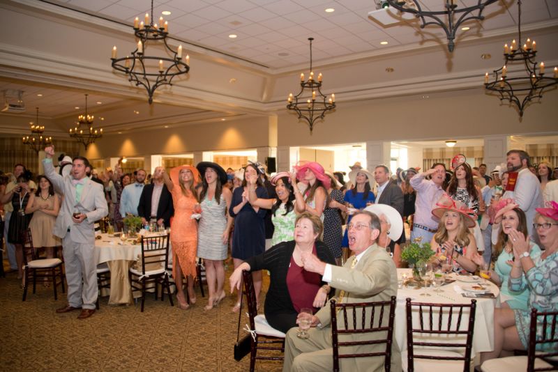 Party-goers cheered as the horses raced around the track.