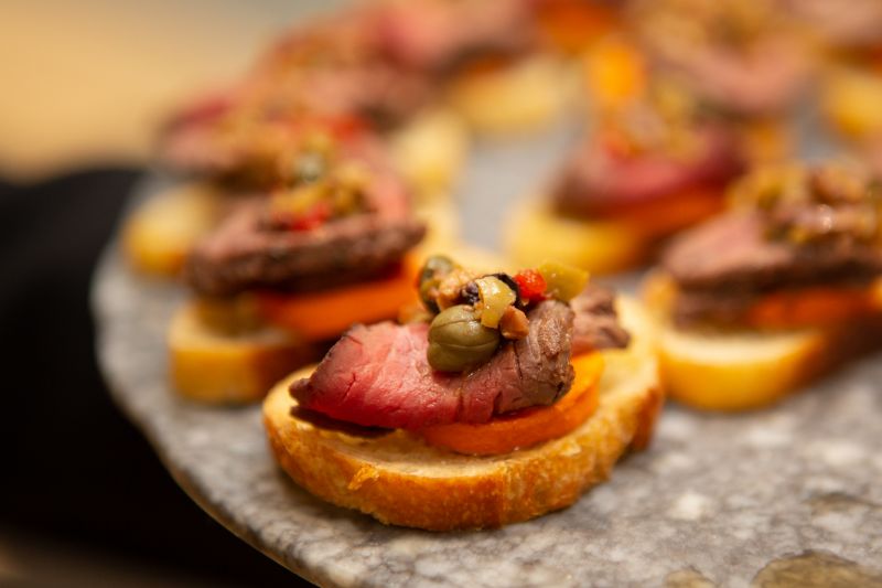 Filet mignon with peperchilies on a rostini were one of the many delectable hors d&#039;oeuvres served on marble slabs.