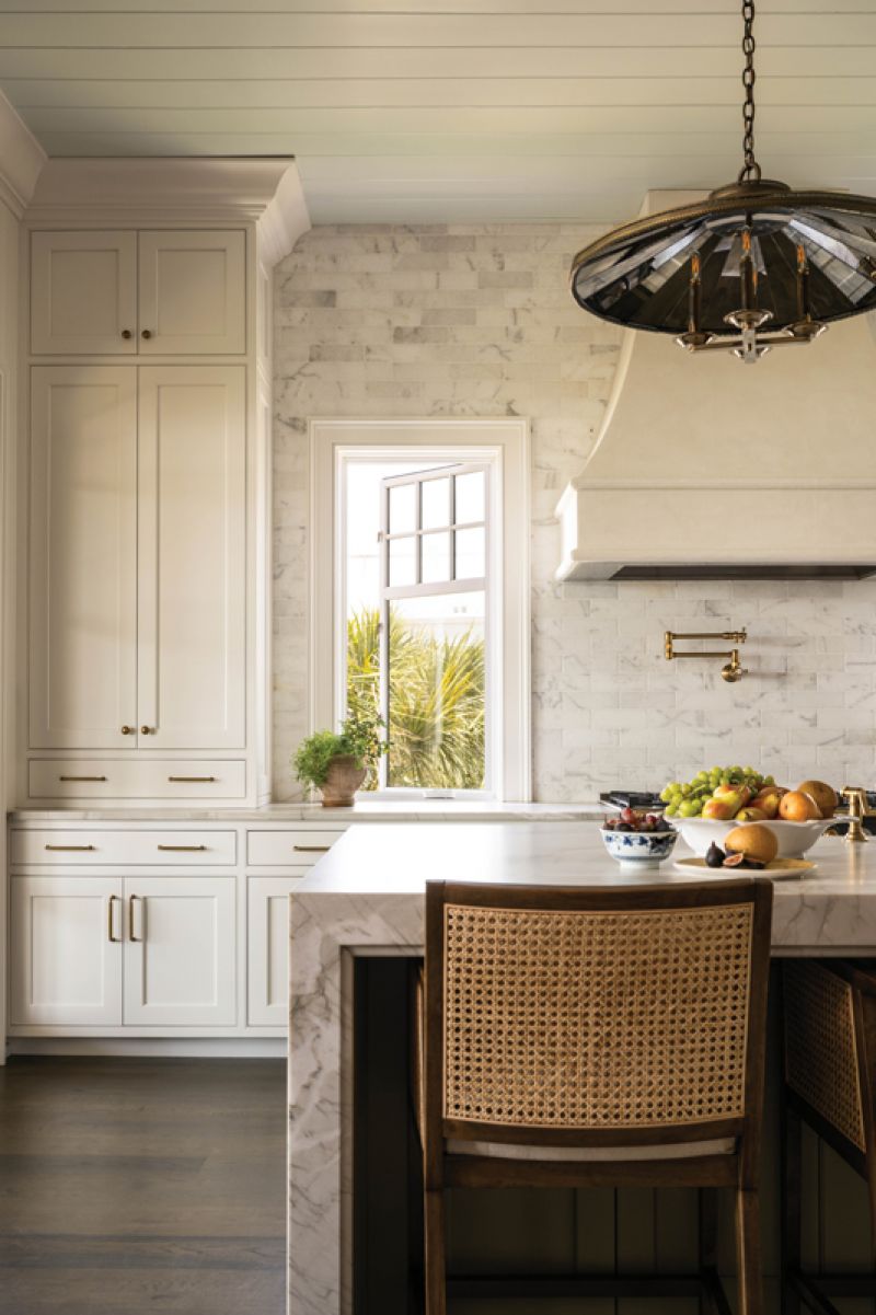 Original Baker chairs recovered in Claremont and Calvin fabrics up the luxe factor in the dining area.