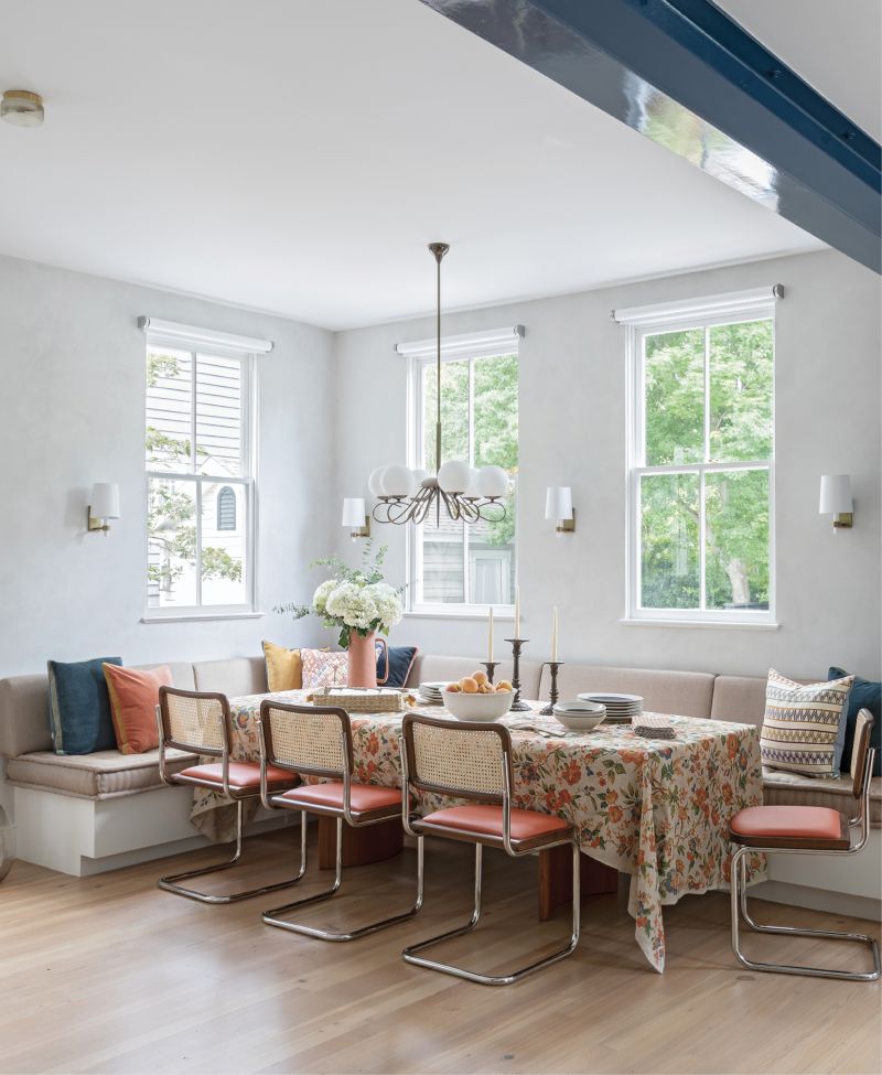 Beam It Up: Previously a screened-in porch, this dining space in the now-enlarged kitchen is the perfect place for the Newmans’s two daughters and their friends to hang out, or to gather the family for a meal. A long banquette extends the full width of the room providing plenty of space to spread out. Marcel Breuer-designed Cesca chairs add mid-century flair, and industrial motorized shades from J Geiger complement the room’s central feature—the architectural steel beam that traverses the space.