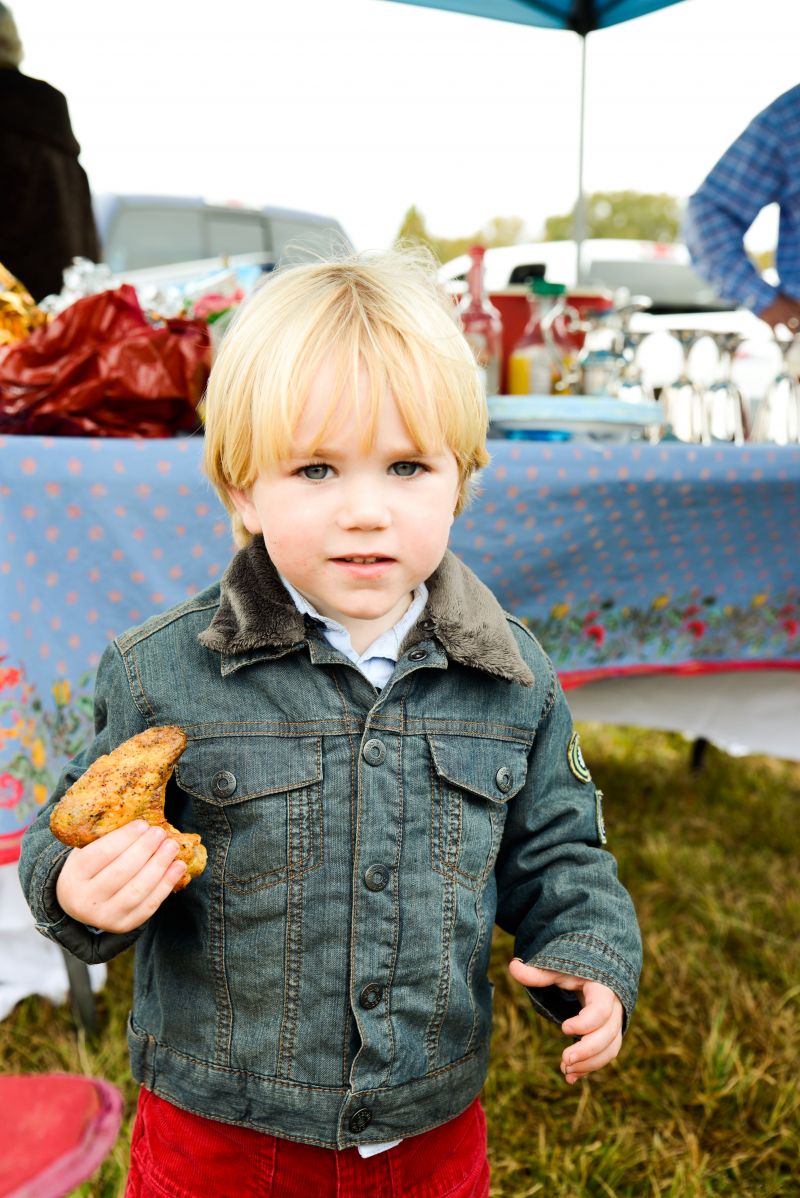 A pint-sized guest prepares to devour some fried chicken.