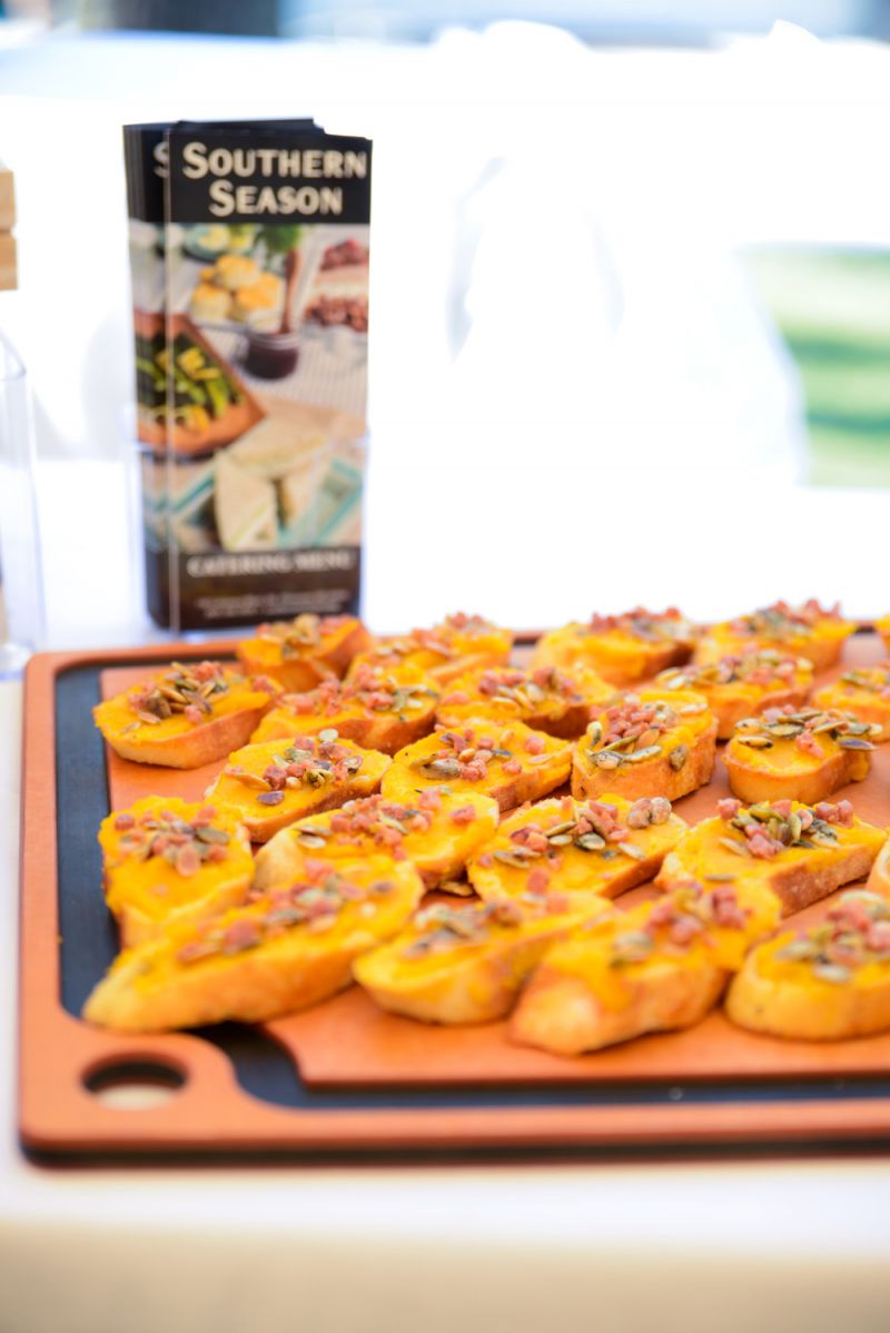 Crostinis with pumpkin puree, prosciutto, and pumpkin seeds by Southern Season