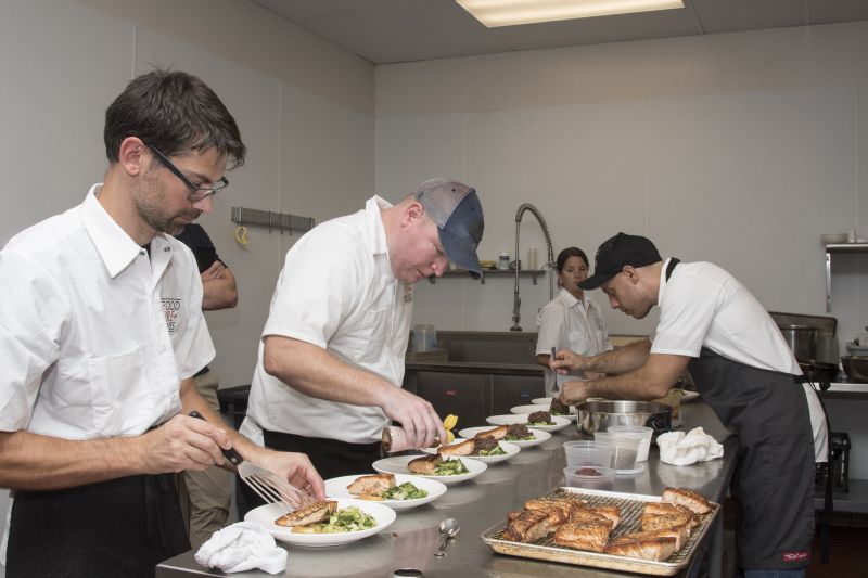 Chefs Pepe, McGarity, and Casciello assemble the second course.