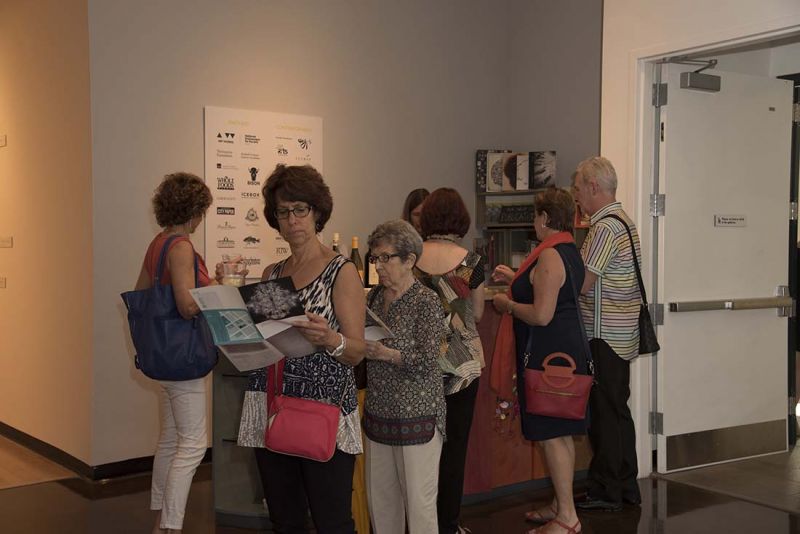 Guests read about the artist before entering the gallery space.