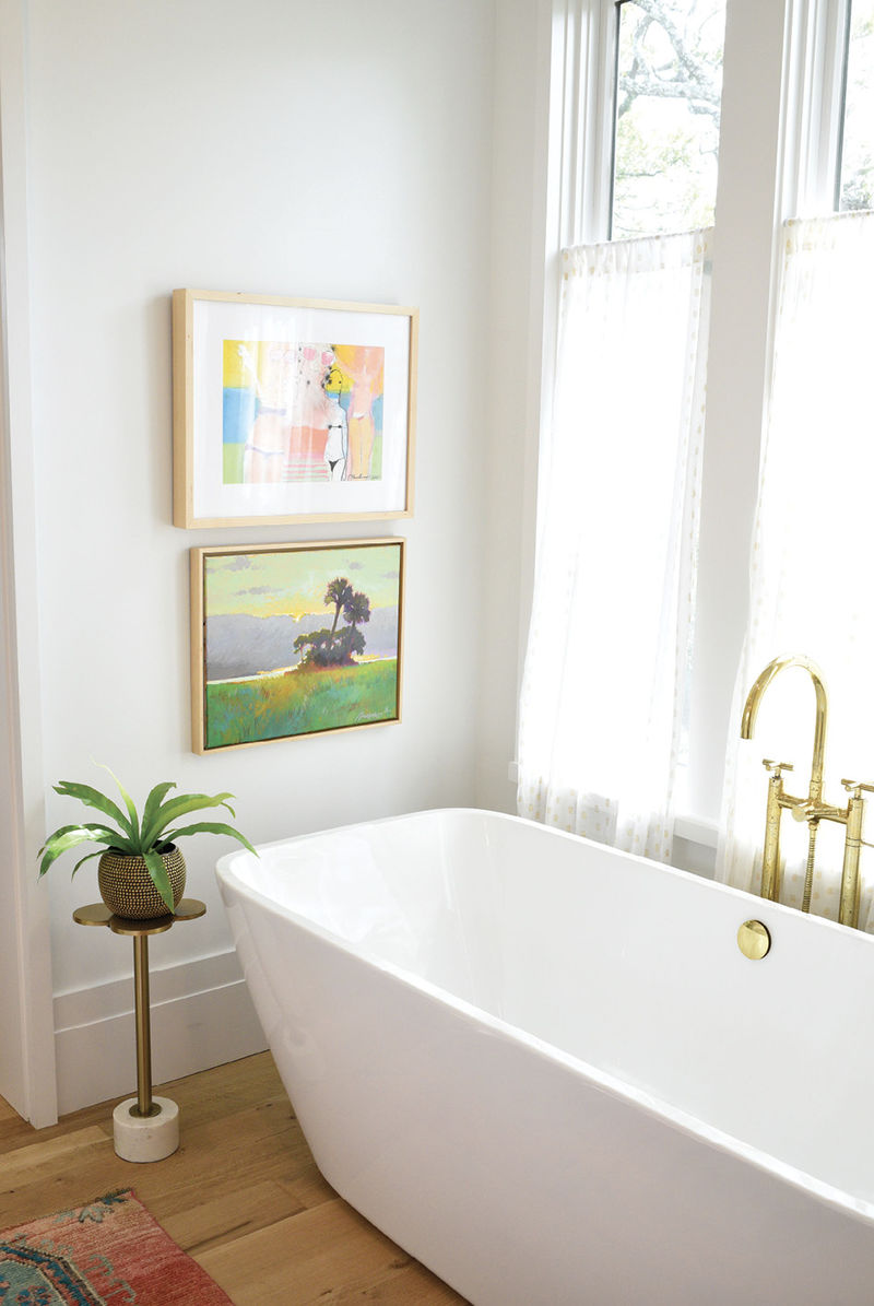 Ella’s en-suite, a diminutive replica of her mom and dad’s grand bath, also boasts plenty of natural light. The freestanding tub with unlacquered brass fixtures, both from Moluf’s, continues the home’s brass theme, and a vintage Turkish rug over the white oak floor completes the relaxed yet elegant look.