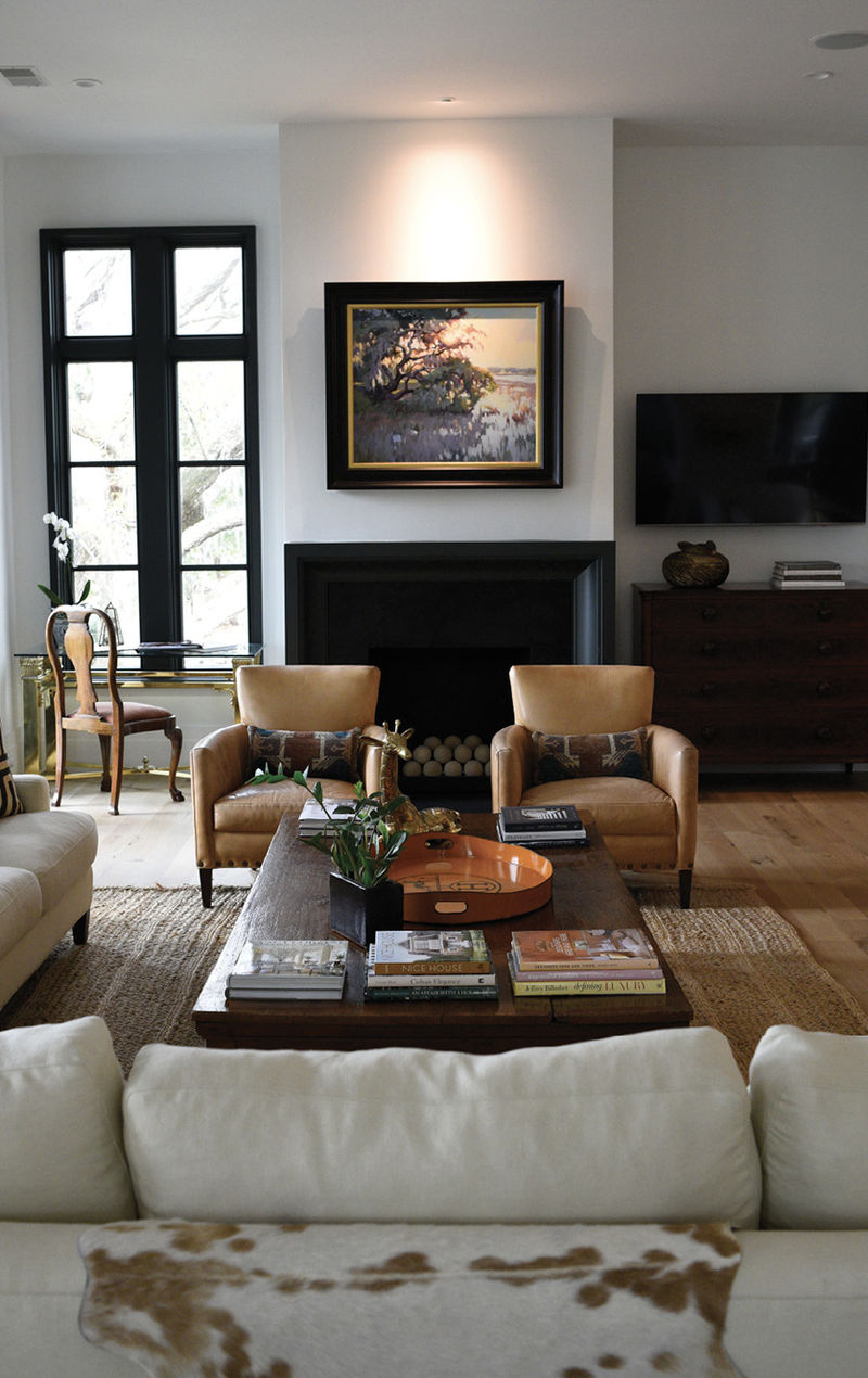 Local artist Jennifer Black’s marsh scene takes pride of place above the custom millwork mantel. Beneath, gas fireballs nestle in the soapstone surround to warm up the home on wintry days.