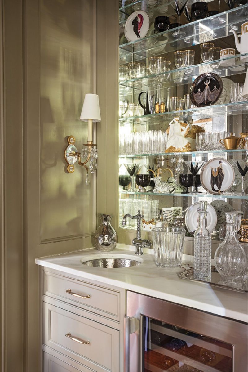 Glass, metallics, and mirrors make the bar nook glow.