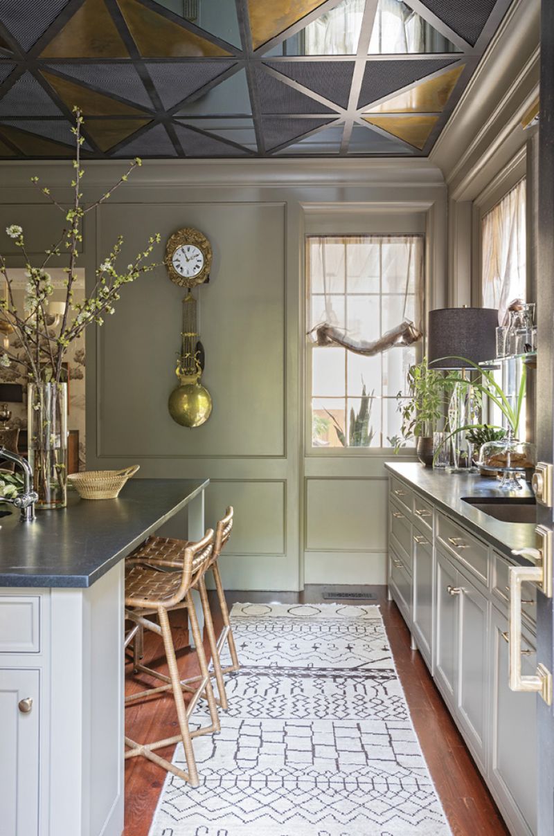 Tyler Hill designed the industrial-glam ceiling, which consists of mirrored and aged brass triangles set within a metal frame.