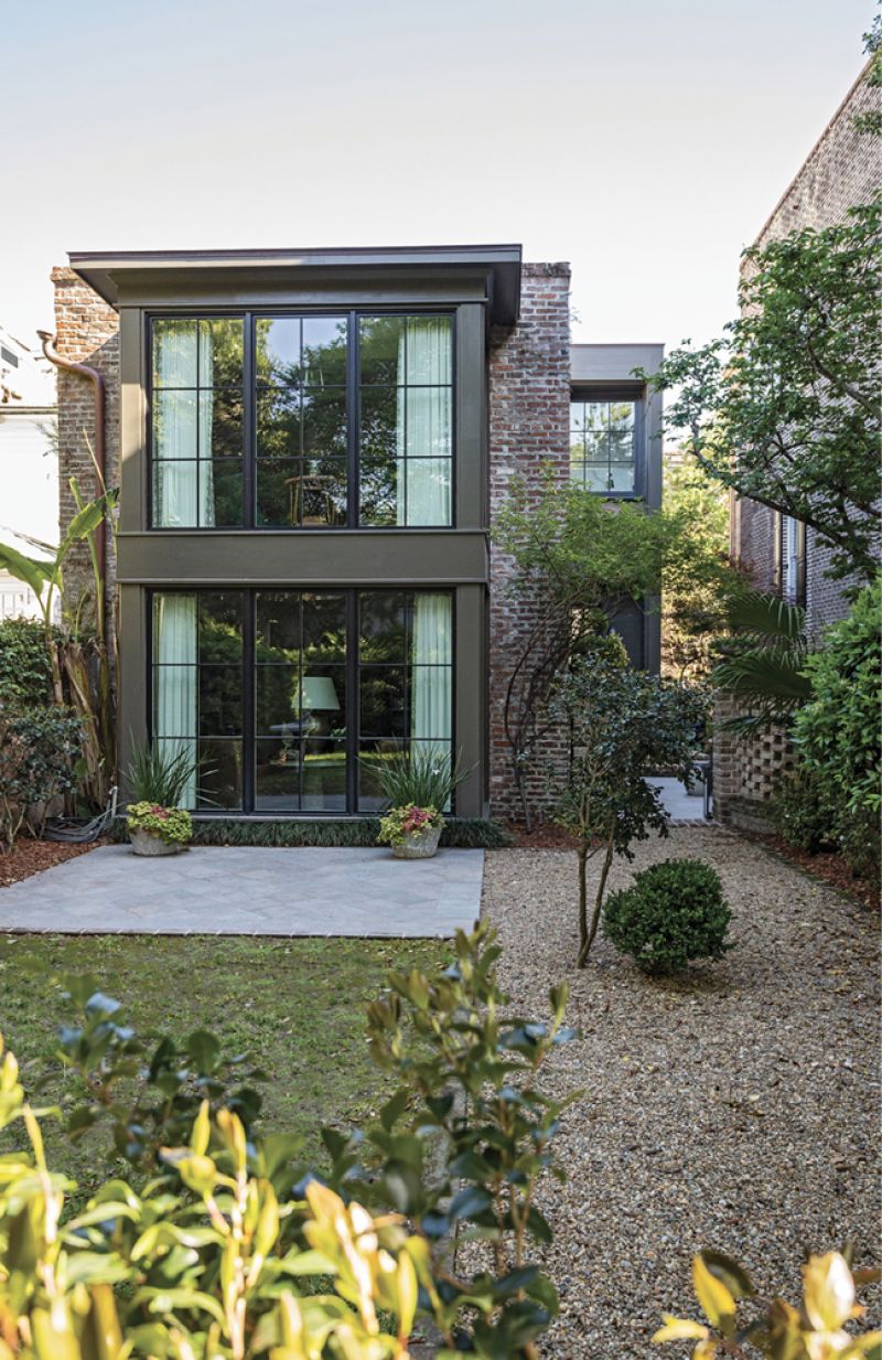 To add square footage and usher in natural light, floor-to-ceiling windows were added to the rear of the property. “This is my next place to start collecting for,” Michael says of the garden.