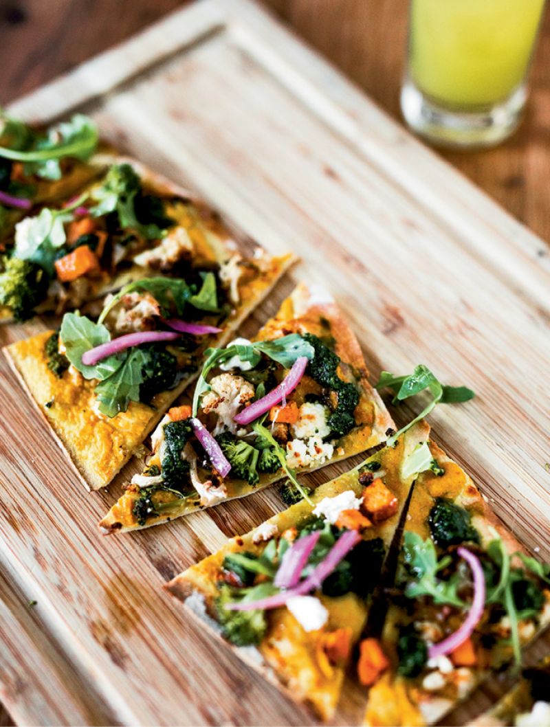 Fresh Slice: Seasonal produce shines in a vegetarian flatbread with curry cauliflower purée, sweet potatoes, broccoli, cauliflower, and goat cheese.