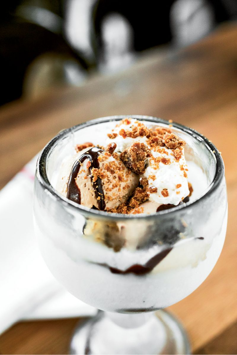 An ice-cream sundae doused with Nutella sauce and pralines