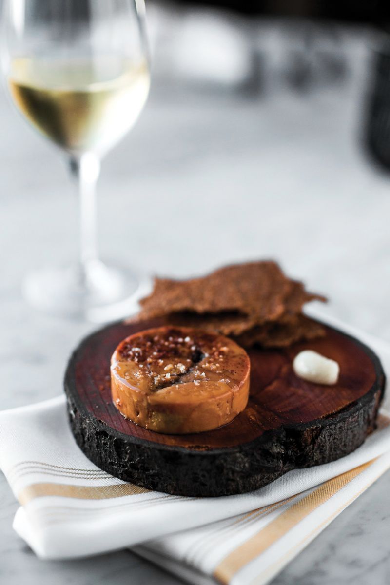 Sear Genius: Plancha-grilled short ribs deliver a nutty crunch when crowned with popped sorghum. Expertly charred squash rosettes and tender Brussels sprouts round out the presentation.