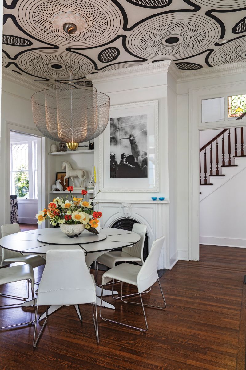 Designer Ghislaine Viñas’s “ShweShwe” wallpaper elevates graphic action on the high ceilings and meshes with the 19th-century egg-and-dart molding and ceiling medallion. A vintage Dirk Wynants “Arthur” dining table echoes the circular designs, and a Moooi “Meshmatics” light fixture reflects the Mendezes’ love of Dutch design.