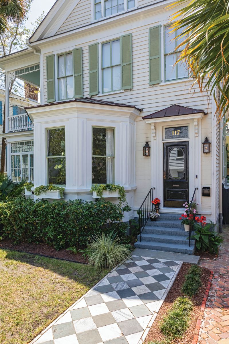 The harlequin-patterned walk hints at the sophisticated whimsy inside.