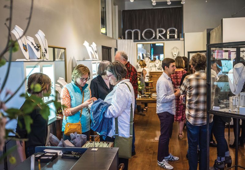 Mora in downtown Asheville (above) sells jewelry made by artists, many of them local. Gems and precious metals can be found, as well as earrings made from 3-D printed plastic. (Below) Sarah Wells Rolland at work at The Village Potters Clay Center in the River Arts District, or “RAD,” as it’s known.