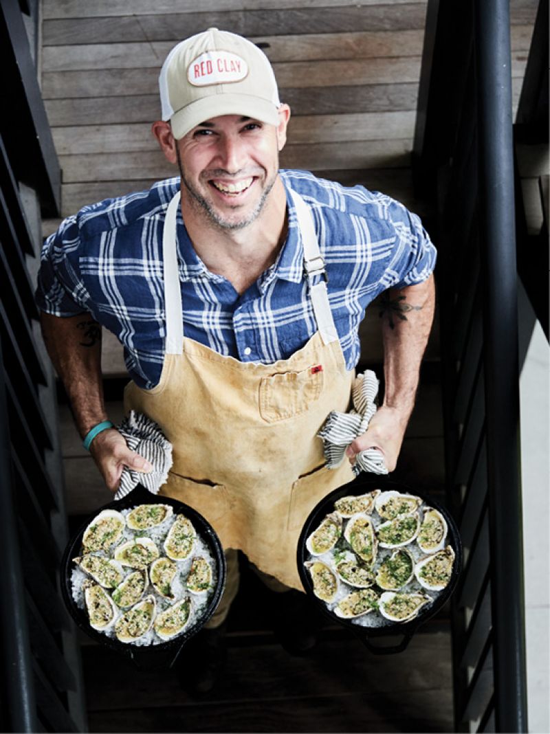 Geoff heads to the side yard with another round of his oysters dressed in furikake butter.