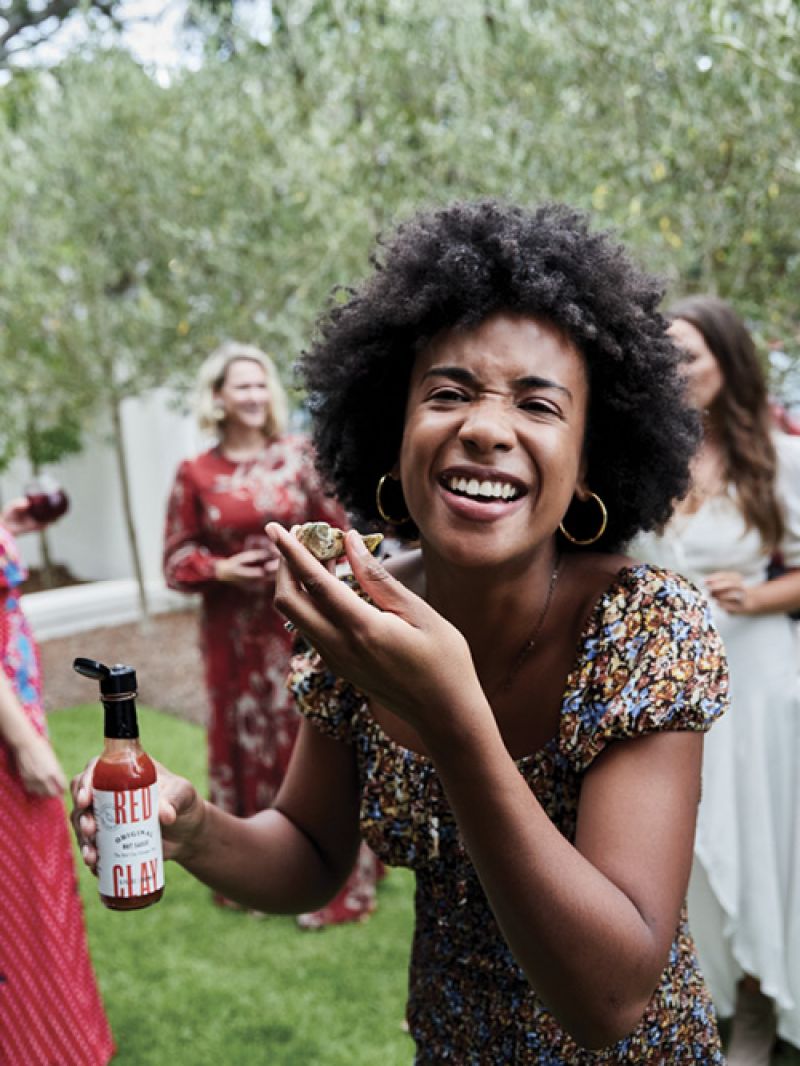 Quincie Bardsley tops her oyster with Red Clay’s Original formula.