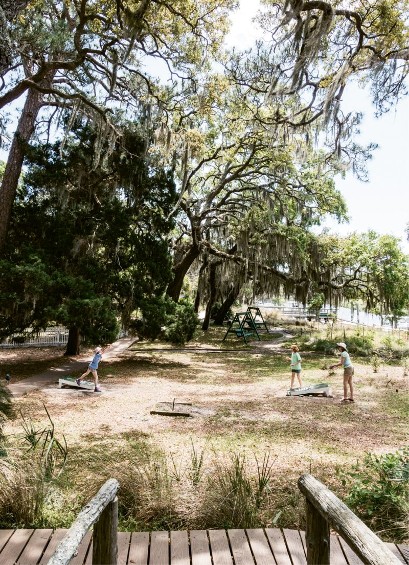 A round of cornhole on the ground.