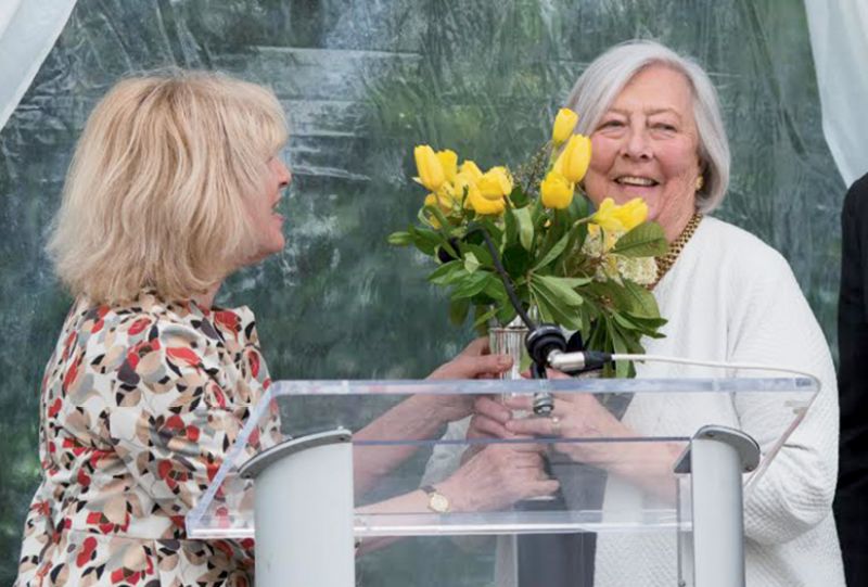 Paula Robison presenting flowers and the award to Evelyn McGee