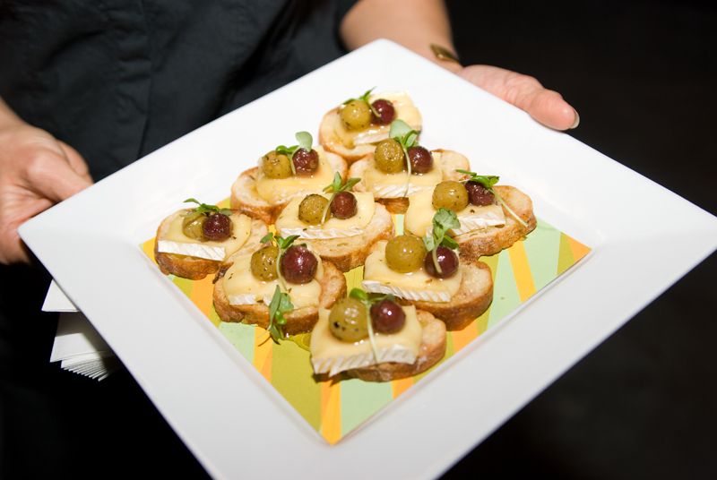 Roasted grapes on brie, crostini, and local honey from Cru Catering