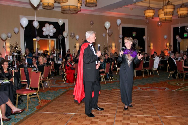 Board member Hank Greer and founder-president Carol Linville address the audience about the important work of Pet Helpers.