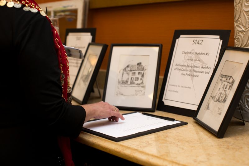 A guest contemplated bidding on one of the silent auction items.