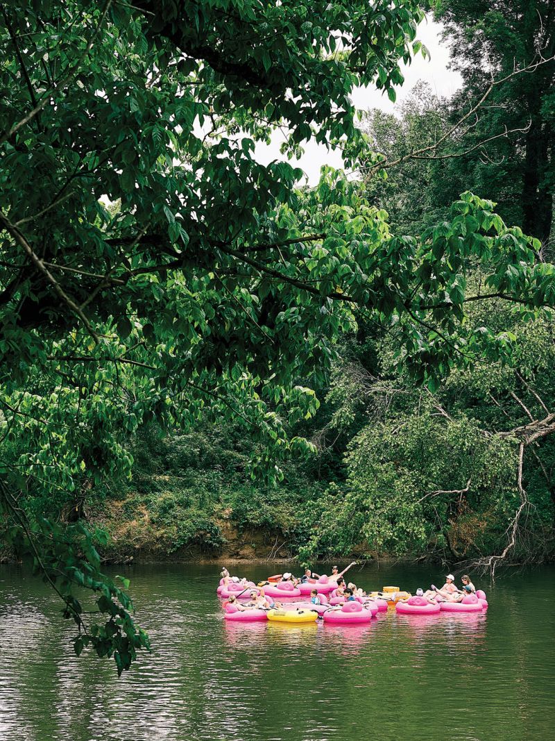 Inner tubers floating by the Wrong Way River Lodge