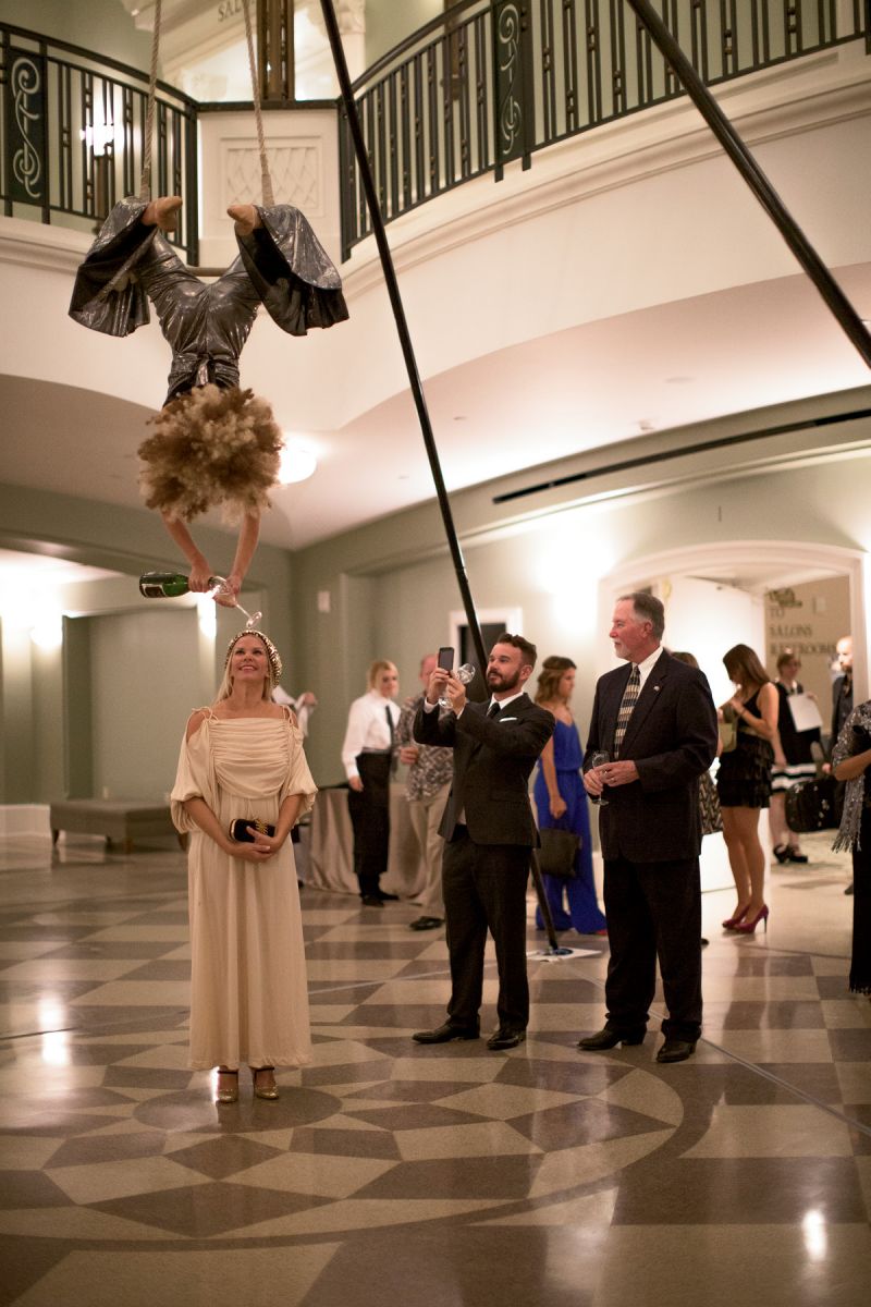 An aerialist bartender from Elevate poured Biltmore Estate bubbles from above as guests entered the Grand Foyer