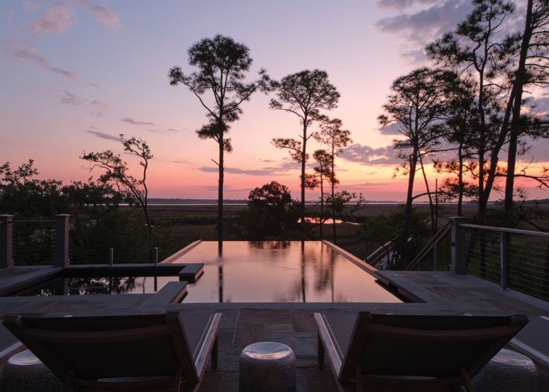 A cozy porch on the second floor, off the primary bedroom suite, is Stewart’s favorite spot to sit and soak up the scenery, while Susan prefers the porch swing on the far edge of the lower deck.